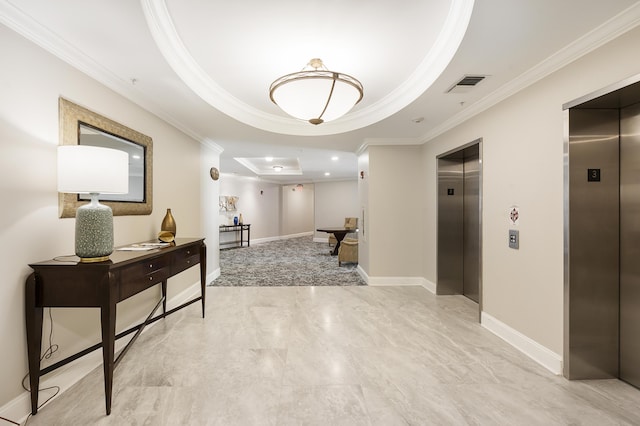 hall featuring a tray ceiling, visible vents, elevator, and ornamental molding