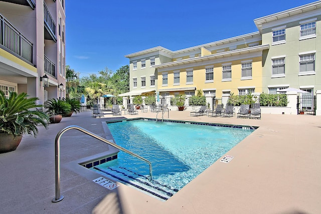 pool featuring a patio area and fence