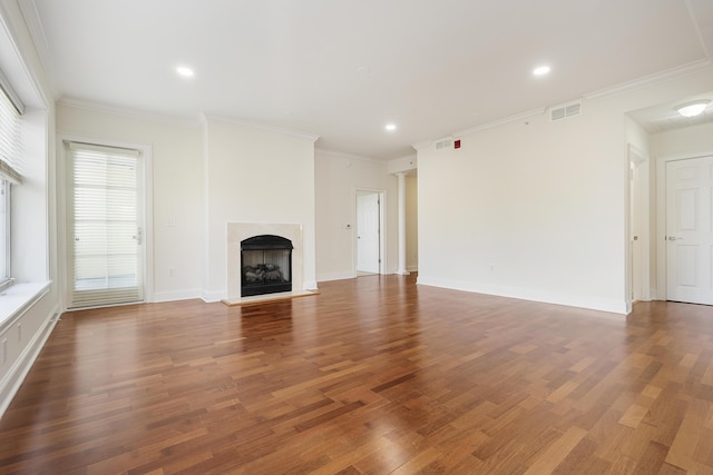 unfurnished living room featuring wood finished floors, a fireplace, visible vents, and baseboards