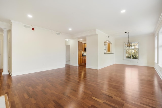 unfurnished living room with dark wood-style floors, visible vents, ornate columns, and ornamental molding