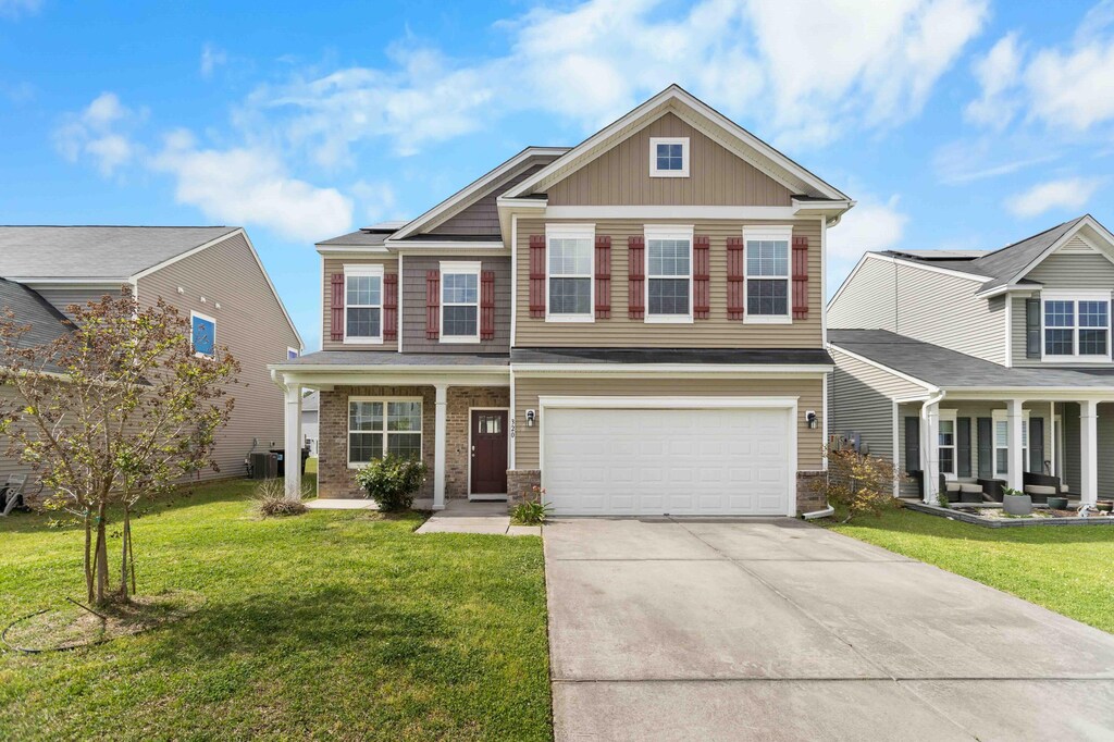 320 Silverleaf Ln, Moncks Corner, SC 29461 - craftsman house featuring driveway, a front lawn, and a porch