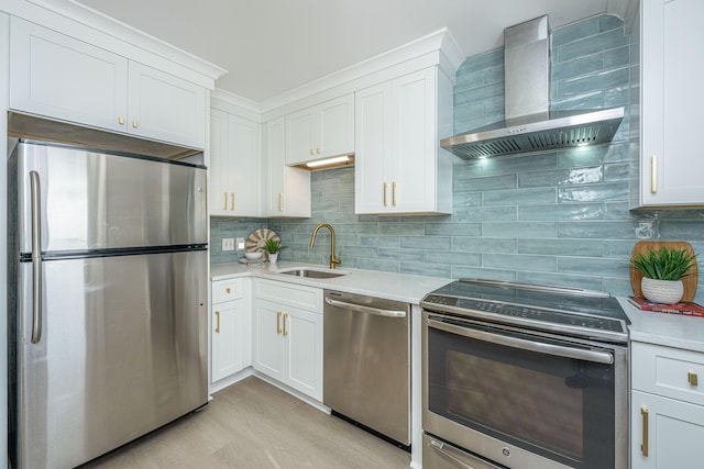 kitchen featuring sink, white cabinets, stainless steel appliances, and wall chimney range hood