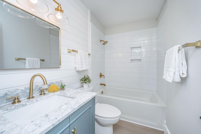 full bathroom with vanity, toilet, and tiled shower / bath combo