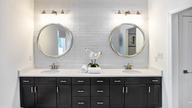 bathroom with vanity and tasteful backsplash