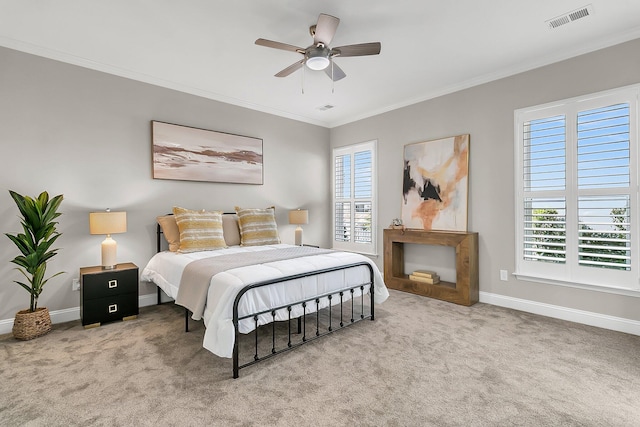 carpeted bedroom featuring ornamental molding and ceiling fan