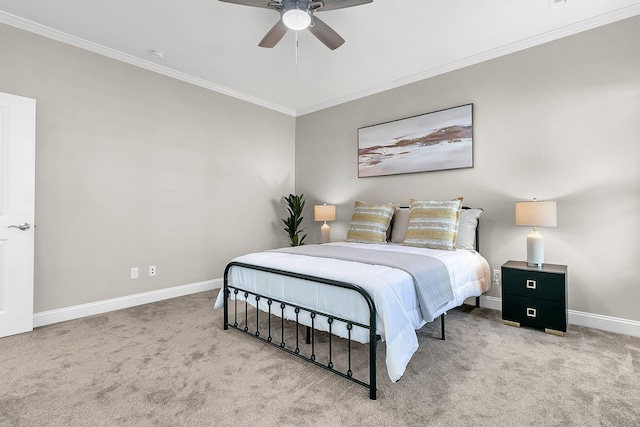 carpeted bedroom with ceiling fan and ornamental molding