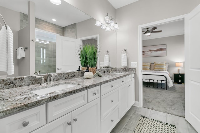 bathroom featuring ceiling fan, vanity, and a shower with door