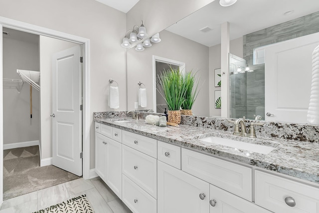 bathroom featuring vanity and an enclosed shower