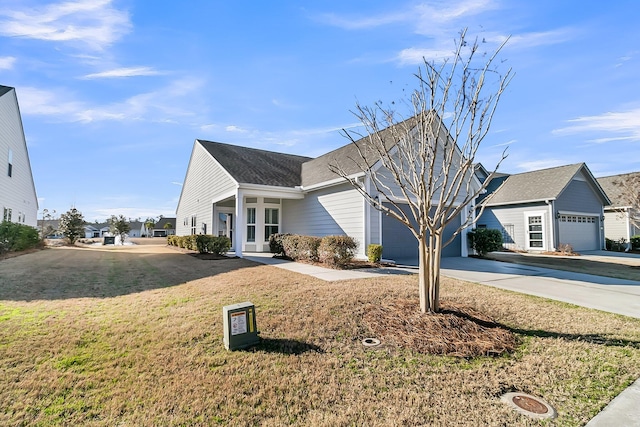 view of front property featuring a garage and a front lawn