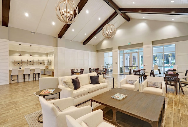 living room featuring beam ceiling, a chandelier, high vaulted ceiling, and light hardwood / wood-style flooring