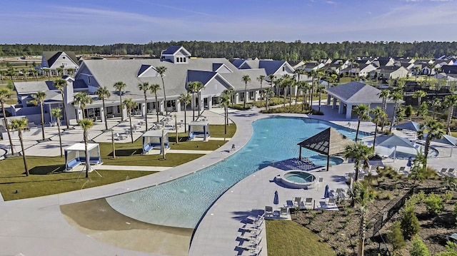 surrounding community featuring a patio, a lawn, and a pool with hot tub