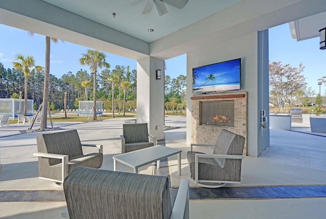 view of patio / terrace featuring an outdoor brick fireplace and ceiling fan