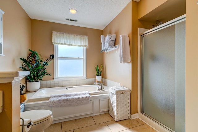 full bathroom with tile patterned floors, visible vents, a garden tub, a stall shower, and a textured ceiling