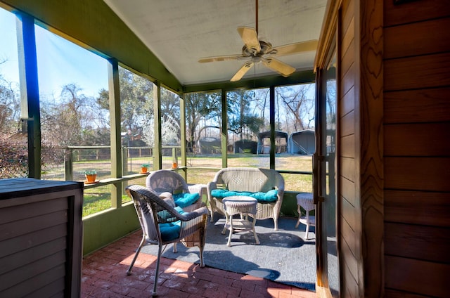 sunroom / solarium featuring ceiling fan