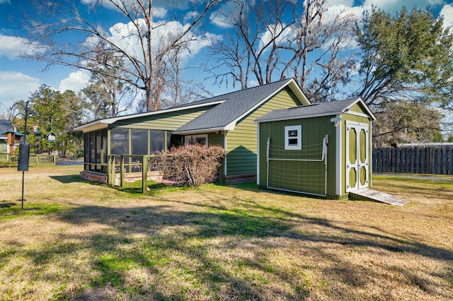 exterior space with a sunroom and fence