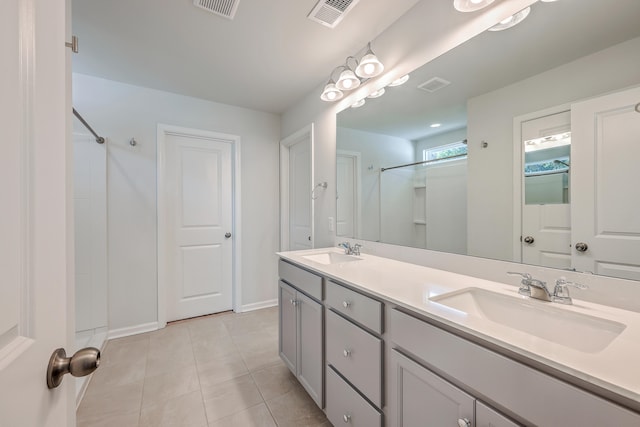 bathroom featuring vanity, tile patterned floors, and a shower with door