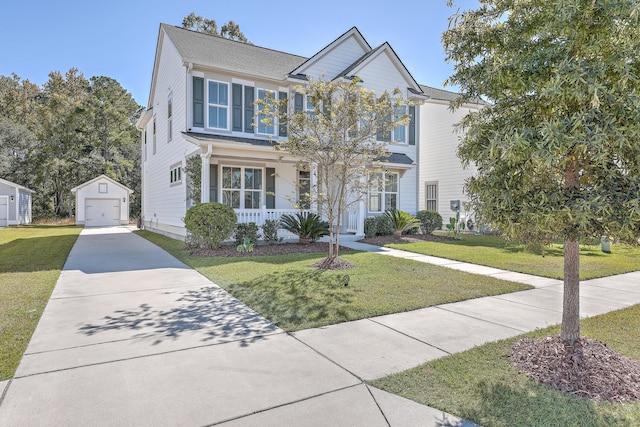 view of front of home featuring covered porch, a garage, a front lawn, and an outdoor structure