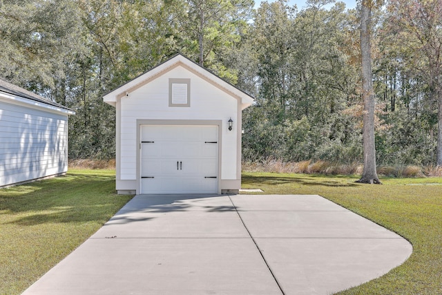 view of outbuilding featuring a garage and a lawn