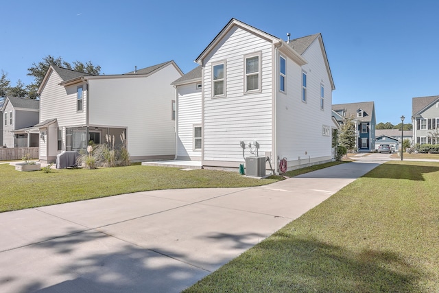 exterior space featuring a yard and central AC unit