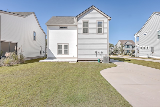 back of property with a patio, a lawn, and central air condition unit