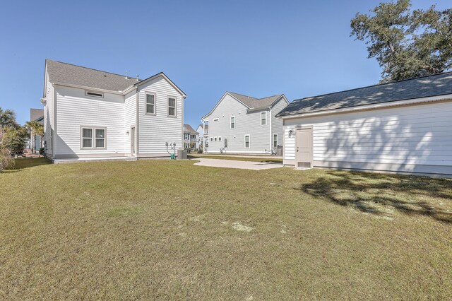 rear view of property with a yard and a patio