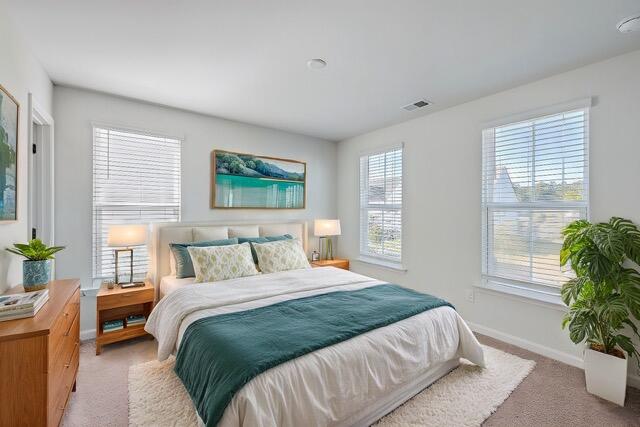 bedroom featuring light carpet