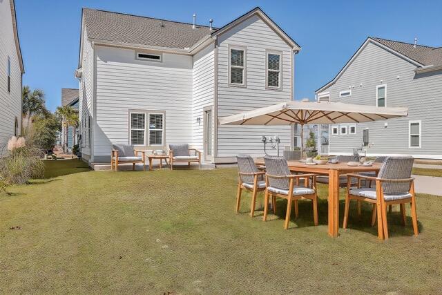 rear view of house with a lawn