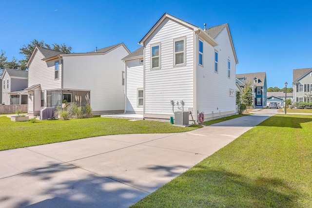 exterior space featuring central AC and a yard