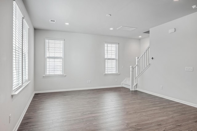 unfurnished room with dark hardwood / wood-style flooring