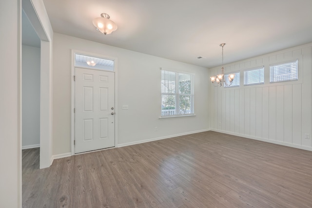 foyer entrance with wood-type flooring and a notable chandelier