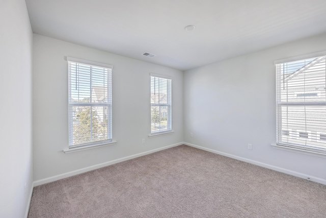 unfurnished room featuring light colored carpet