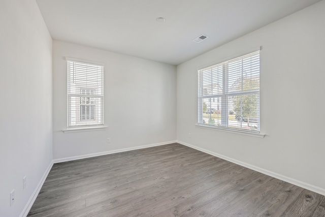 spare room with hardwood / wood-style floors