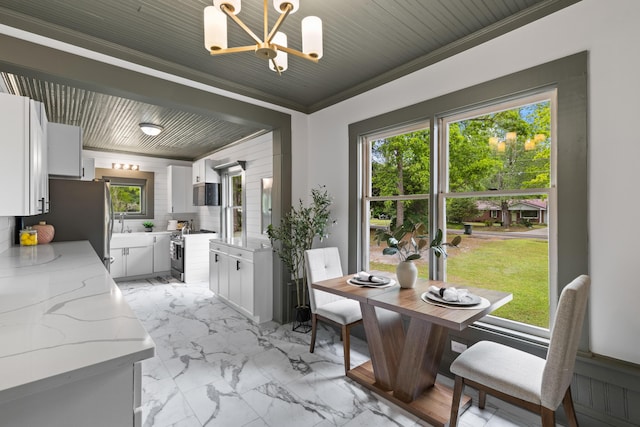 285 Roosevelt Dr, Saint Stephen, SC 29479 - dining area with a chandelier, light marble finish floors, and crown molding