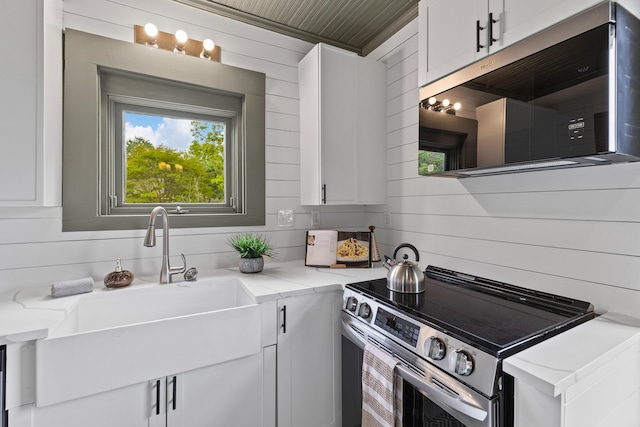 285 Roosevelt Dr, Saint Stephen, SC 29479 - kitchen featuring stainless steel appliances, a sink, white cabinets, and light stone countertops