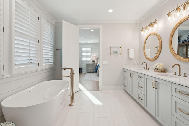 bathroom featuring tile patterned flooring, vanity, a tub, and crown molding