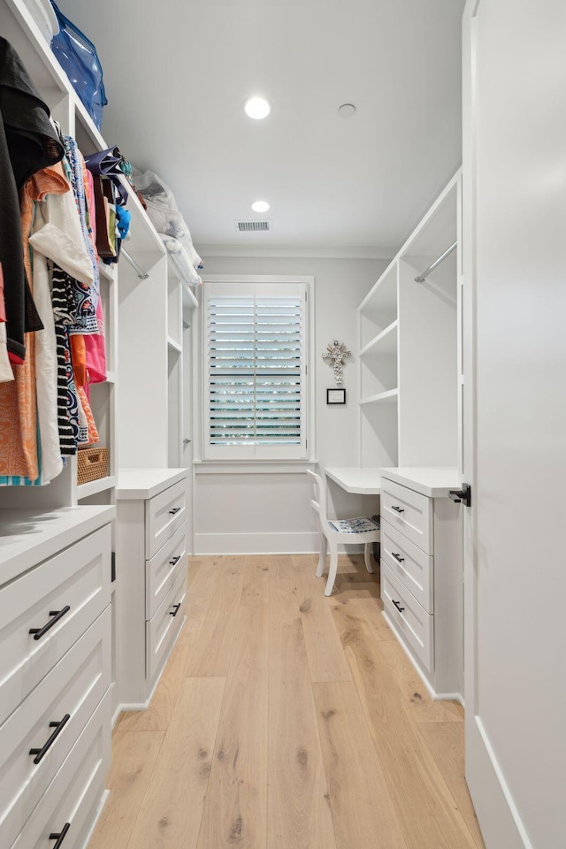 spacious closet with light hardwood / wood-style floors