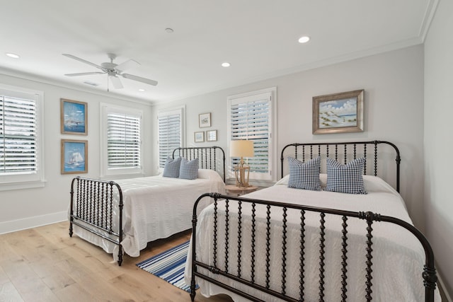 bedroom with ceiling fan, ornamental molding, and light hardwood / wood-style floors