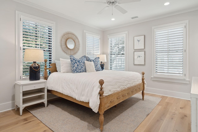 bedroom with ceiling fan, ornamental molding, and light wood-type flooring