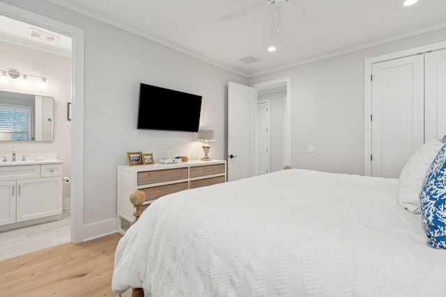 bedroom featuring ensuite bathroom, ceiling fan, ornamental molding, and light hardwood / wood-style flooring