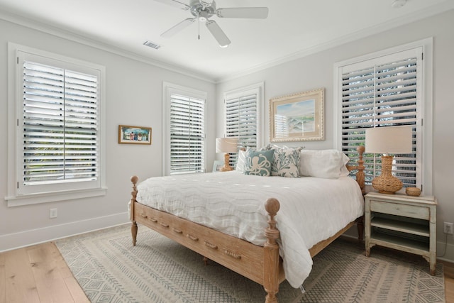 bedroom with ceiling fan, wood-type flooring, and ornamental molding