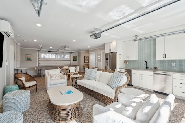 living room featuring an AC wall unit, sink, and crown molding