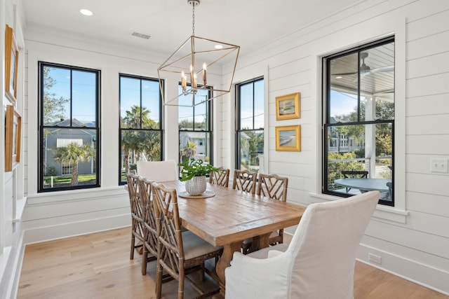 dining space featuring a notable chandelier and light hardwood / wood-style floors