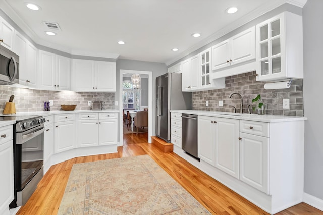 2707 Waterpointe Cir, Mount Pleasant, SC 29466 - kitchen featuring stainless steel appliances, light countertops, a sink, light wood-style flooring, and recessed lighting