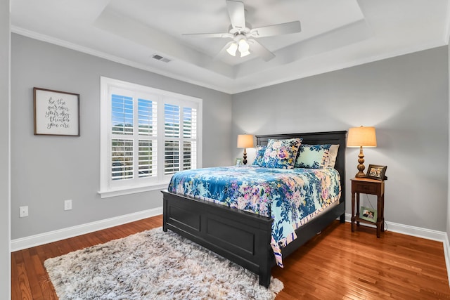 2707 Waterpointe Cir, Mount Pleasant, SC 29466 - bedroom with a tray ceiling, wood finished floors, baseboards, and ceiling fan
