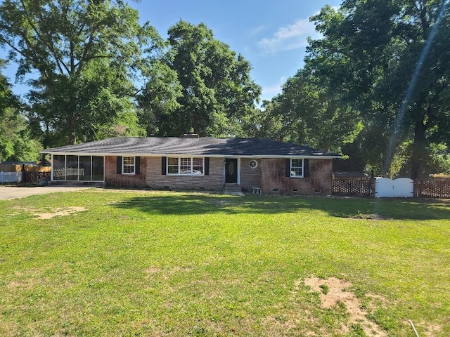 single story home with a sunroom and a front yard