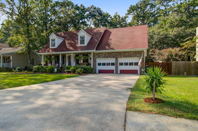 new england style home featuring a front lawn, a porch, and a garage