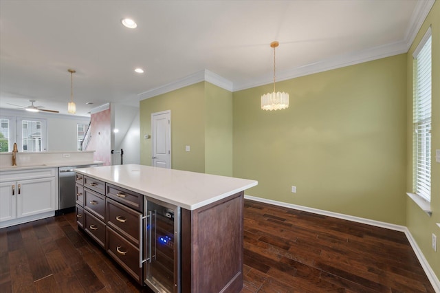 1533 Bluewater Way, Charleston, SC 29414 - kitchen featuring wine cooler, stainless steel dishwasher, dark wood-type flooring, white cabinets, and ornamental molding