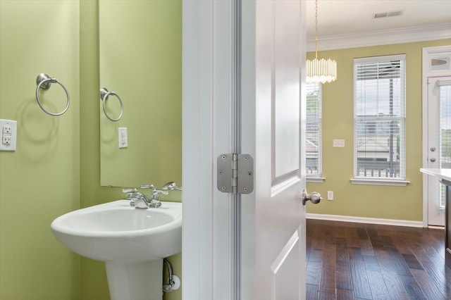 1533 Bluewater Way, Charleston, SC 29414 - bathroom with ornamental molding, hardwood / wood-style floors, baseboards, a sink, and a chandelier
