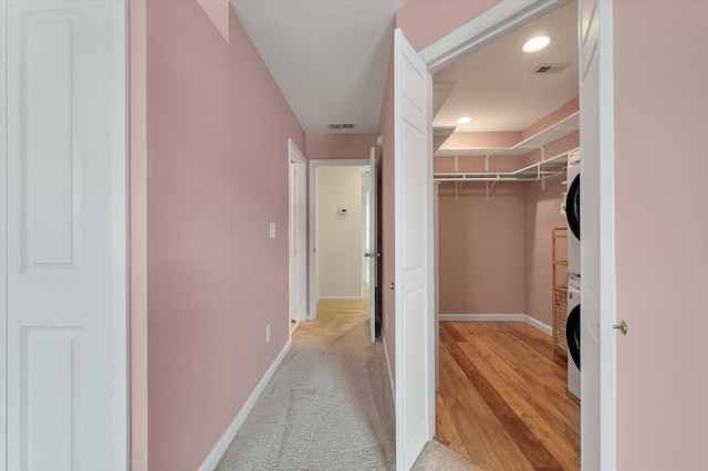 1533 Bluewater Way, Charleston, SC 29414 - walk in closet featuring stacked washer / drying machine and light wood-style floors