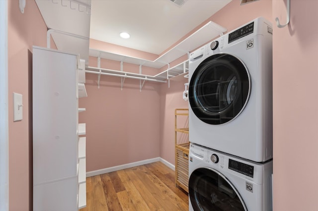 1533 Bluewater Way, Charleston, SC 29414 - washroom featuring stacked washer and clothes dryer, light wood-type flooring, baseboards, and recessed lighting